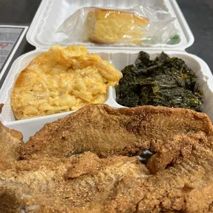 Fried fish platter with two sides and corn bread. DELICIOUS