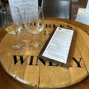 wine glasses and menu on a barrel