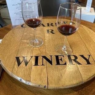 two glasses of wine on a barrel