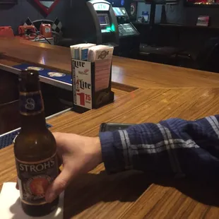 a person holding a beer