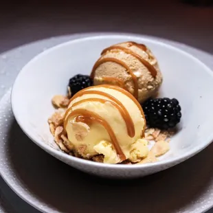 a bowl of ice cream and berries