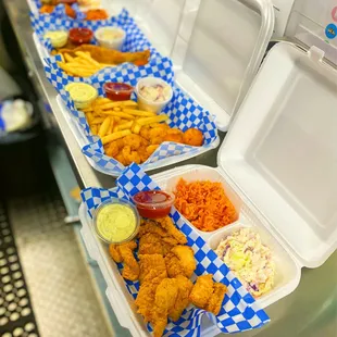 a row of trays of food