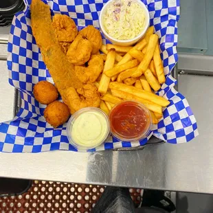 a basket of fried fish and fries
