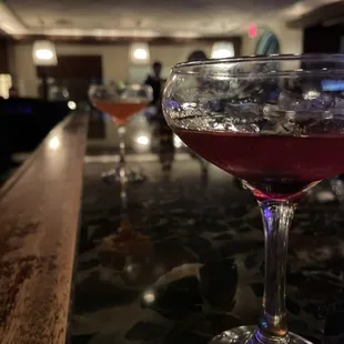 a glass of wine on a bar