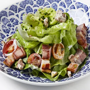 a salad in a blue and white bowl