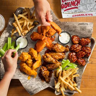 a tray of chicken wings and fries