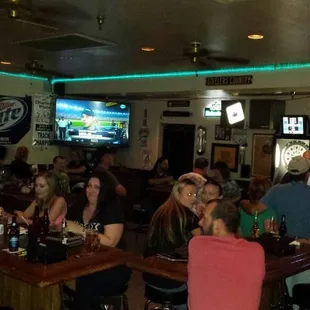 a large group of people sitting at a bar