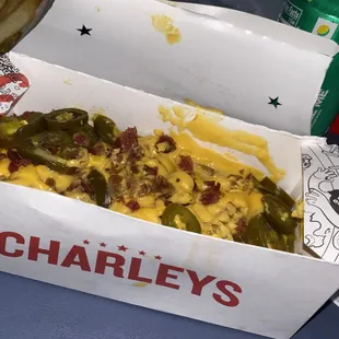 a hot dog with cheese and pickles