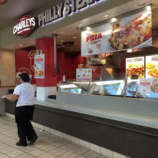 a woman standing in front of a restaurant