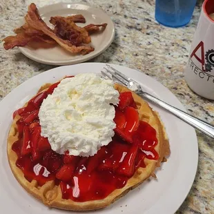 Belgium Waffle topped with strawberries and Whipped Cream. Very tasty@