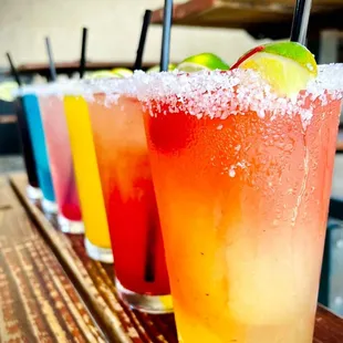 a row of cocktails