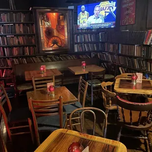 tables and chairs in front of a television