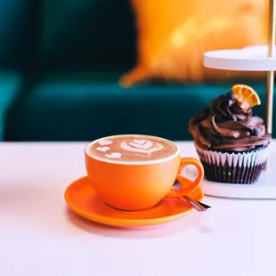 a cup of coffee and a cupcake