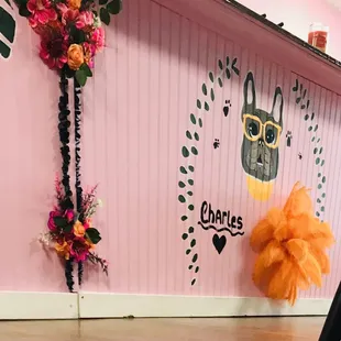 a pink wall decorated with flowers