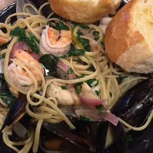 Clams, mussels and shrimp over li pasta in a lemon, butter, capers white wine sauce