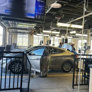 Getting the Works! After the car wash they are now cleaning the interior of my car.