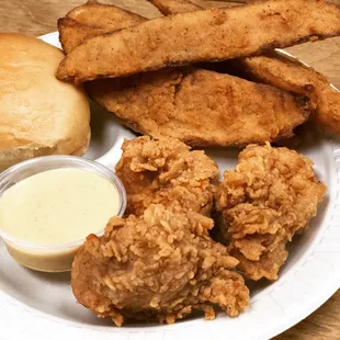 a plate of fried chicken, french fries, and a roll