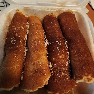 Pigs in a blanket. Pancakes are way too big for the tiny sausage inside.