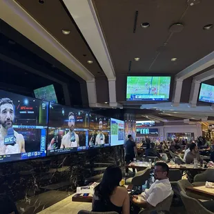 Seating area, TVs everywhere.