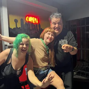 a woman with green hair and a man in a black shirt