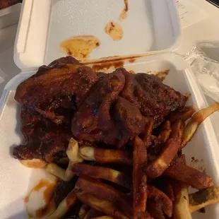 ows ribs and fries in a styrofoam container
