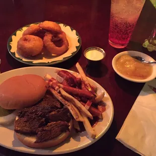 Brisket sandwich with fries in sauce! Onion rings and apple sauce.