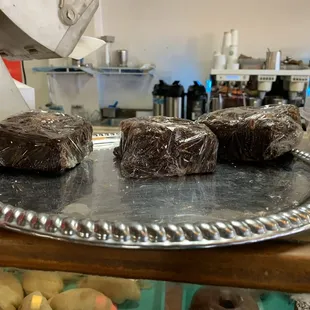 a tray of chocolate donuts
