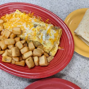Three egg omelet, potatoes and a warm flour tortilla.