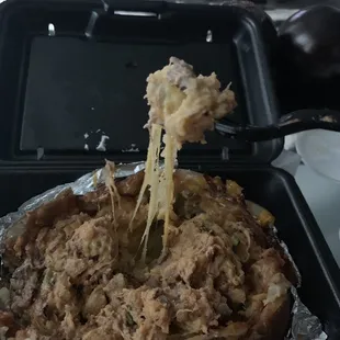 Brisket Loaded Baked Potato, with excessive amounts of cheese.