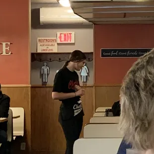 a woman standing in a diner
