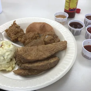 Chicken chunk dinner with mustard potato salad and potato wedges