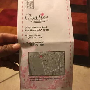 a hand holding a receipt