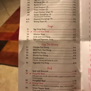 a hand holding a menu