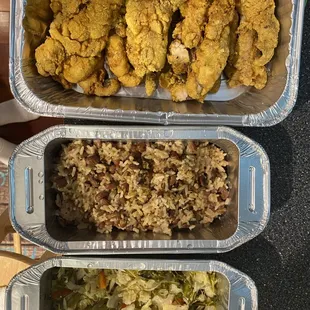 two trays of fried chicken and rice