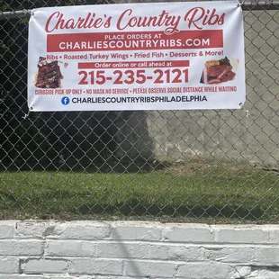 a sign on a chain link fence