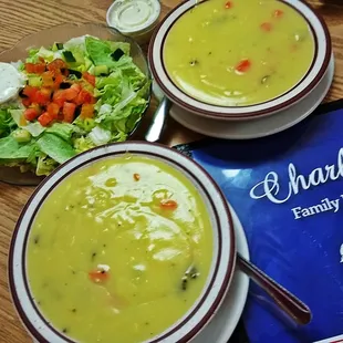 two bowls of soup and a salad