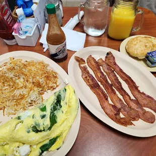Feta and Spinach omelet with hash browns, bacon, biscuit and orange juice