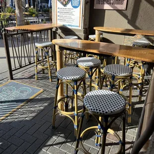 tables and chairs on a sidewalk
