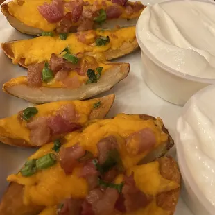 Potato skins with chunky bacon and maybe ham?? Or big chunks of pink bacon fat. Gross.