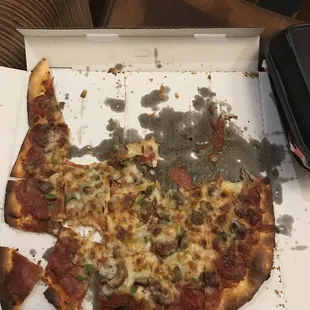 a half eaten pizza in a box