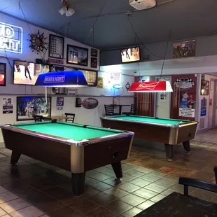 two pool tables and a bar
