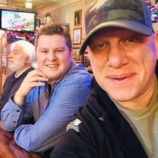two men sitting at a bar