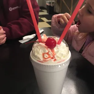 a child drinking a milkshake