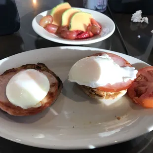 Poached eggs, Canadian bacon, muffins and fruit.