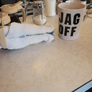 a cup of coffee and a towel on a counter