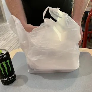 a man holding a bag of food