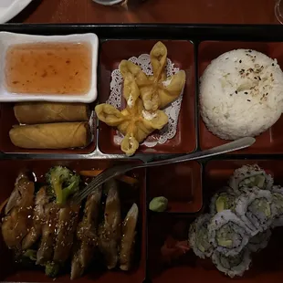Chicken teriyaki bento box  with veggies, 2 spring rolls, crab rangoon, white rice, and a california roll.