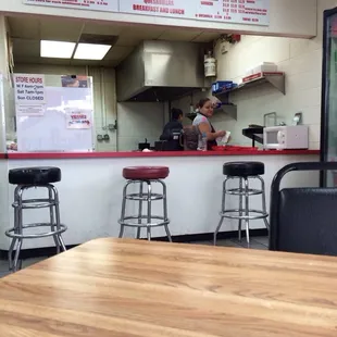 Picture of the food area inside the Valero Gas Station. Only 1 table to sit at plus a counter with a few stools.