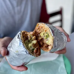 a person holding a burrito