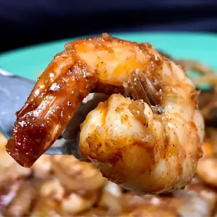 a close up of a forkful of shrimp